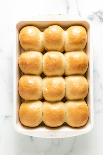 Top down view of dinner rolls in a pan.