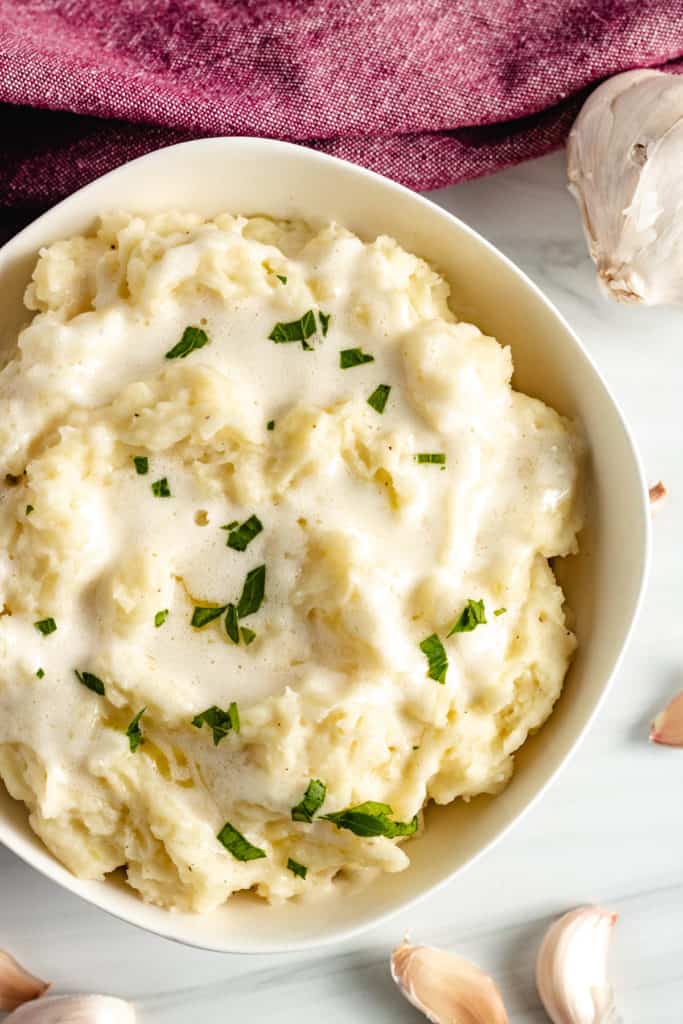 Top down view of garlic mashed potatoes in a bowl.