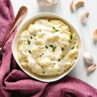 Top down view of a big bowl of mashed potatoes.