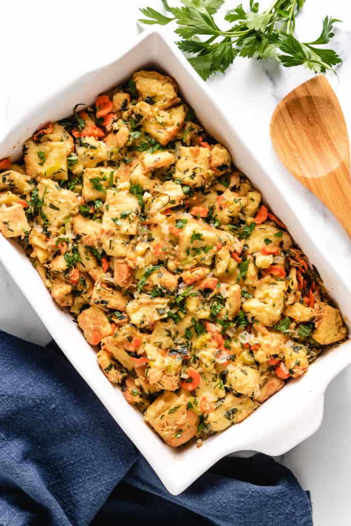 Top down view of herb stuffing with a spoon.