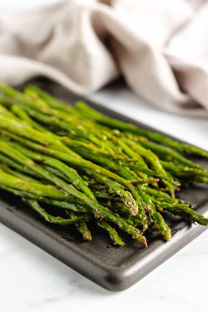 Spears of cooked asparagus on a plate.