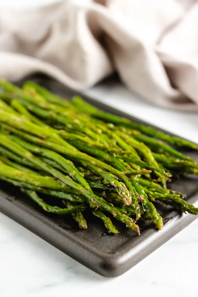 Spears of cooked asparagus on a plate.