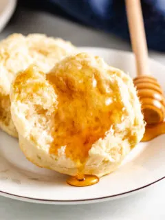 Half a sourdough biscuit topped with honey.