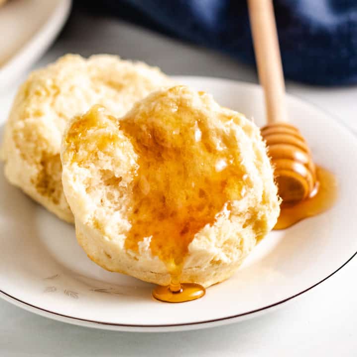 Half a sourdough biscuit topped with honey.