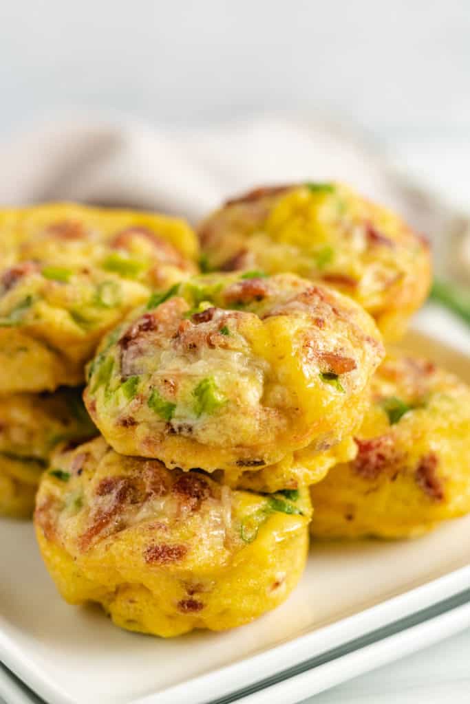 Close up view of bacon egg muffins on a dish.