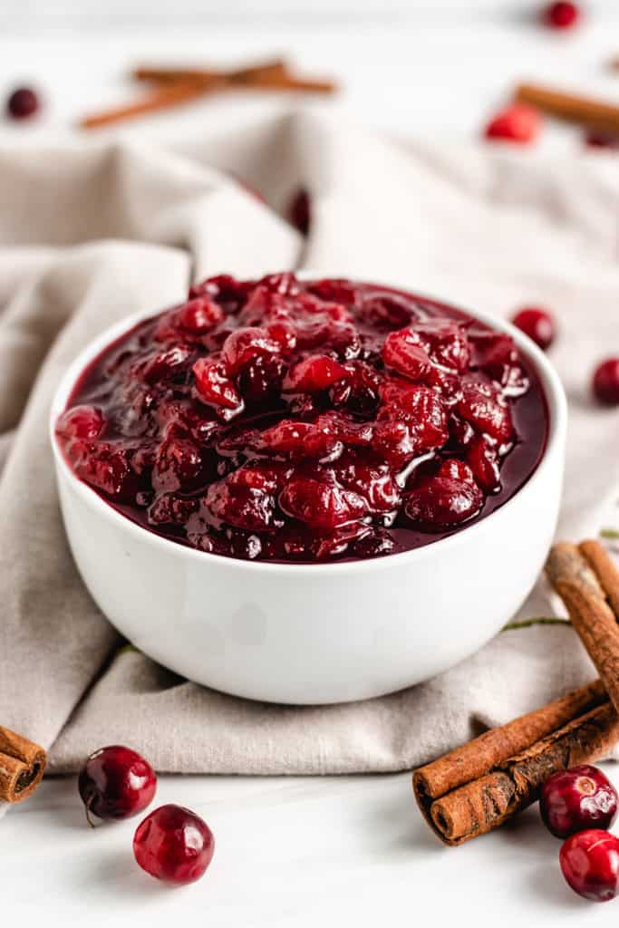 White dish filled with homemade cranberry sauce.