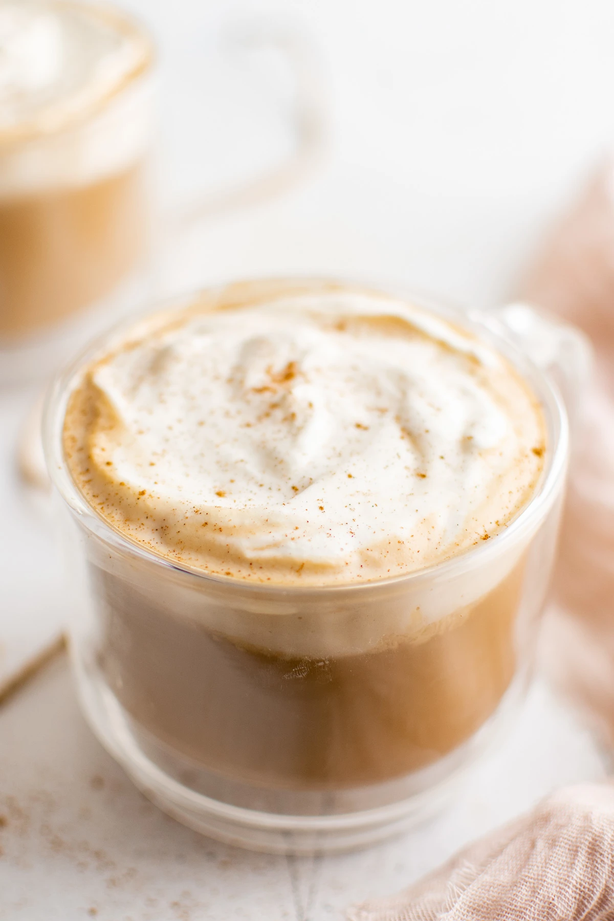 Large mug of eggnog latte with whipped topping.