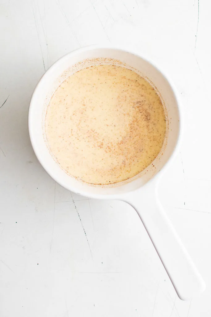 Top down view of eggnog latte in a pan.