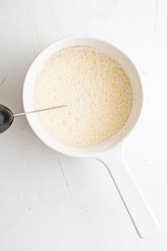 Top down view of frothed milk in a pan.