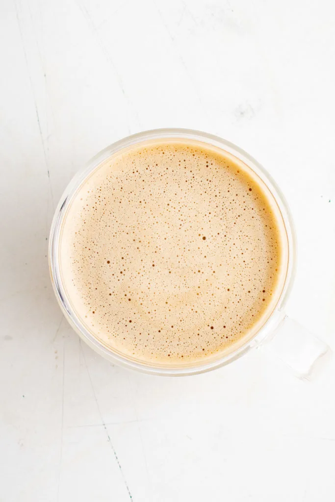 Top down view of eggnog latte in a mug.