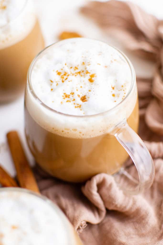 Top down view of a gingerbread latte in a glass mug.