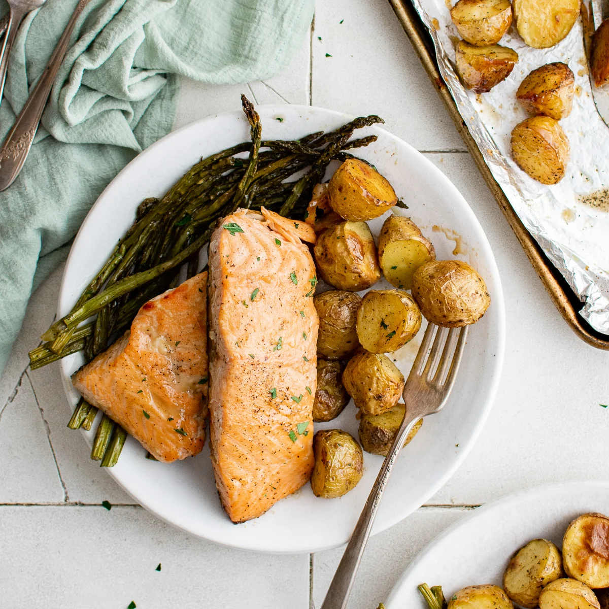 Top down view of sheet pan salmon fillets on a plate.