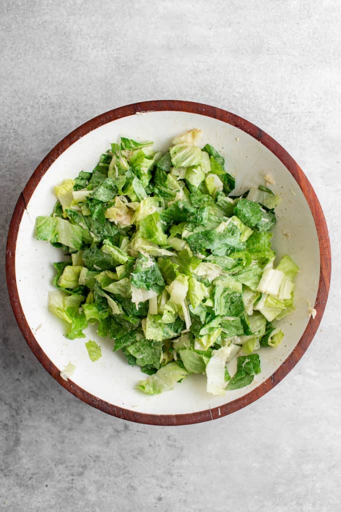 Top down view of salad in a mixing bowl.