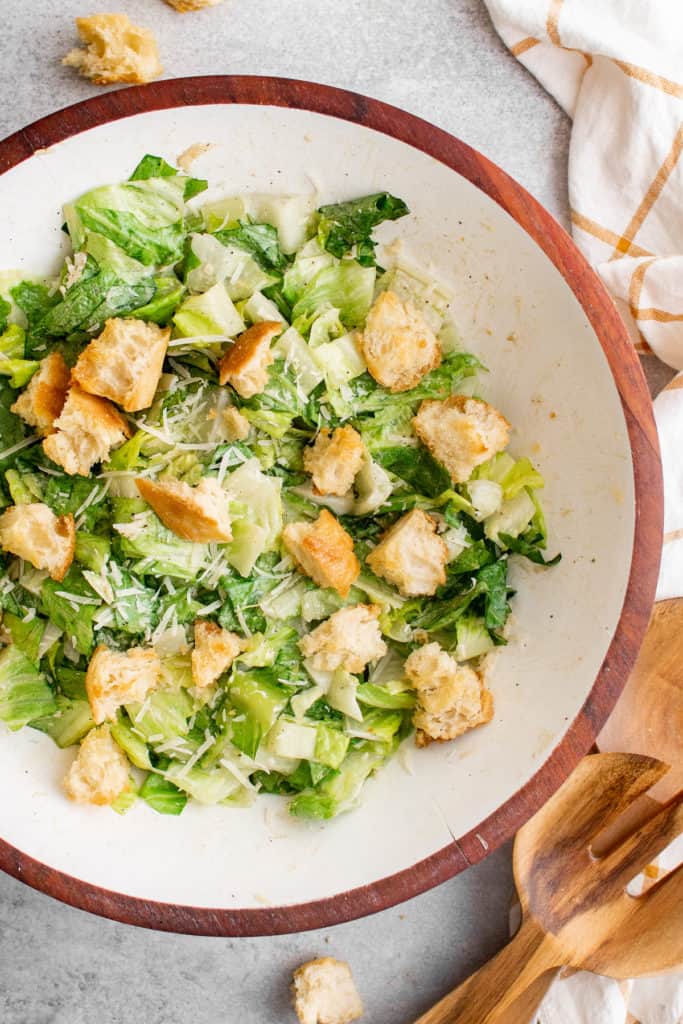 Top down view of a salad and croutons in a bowl.