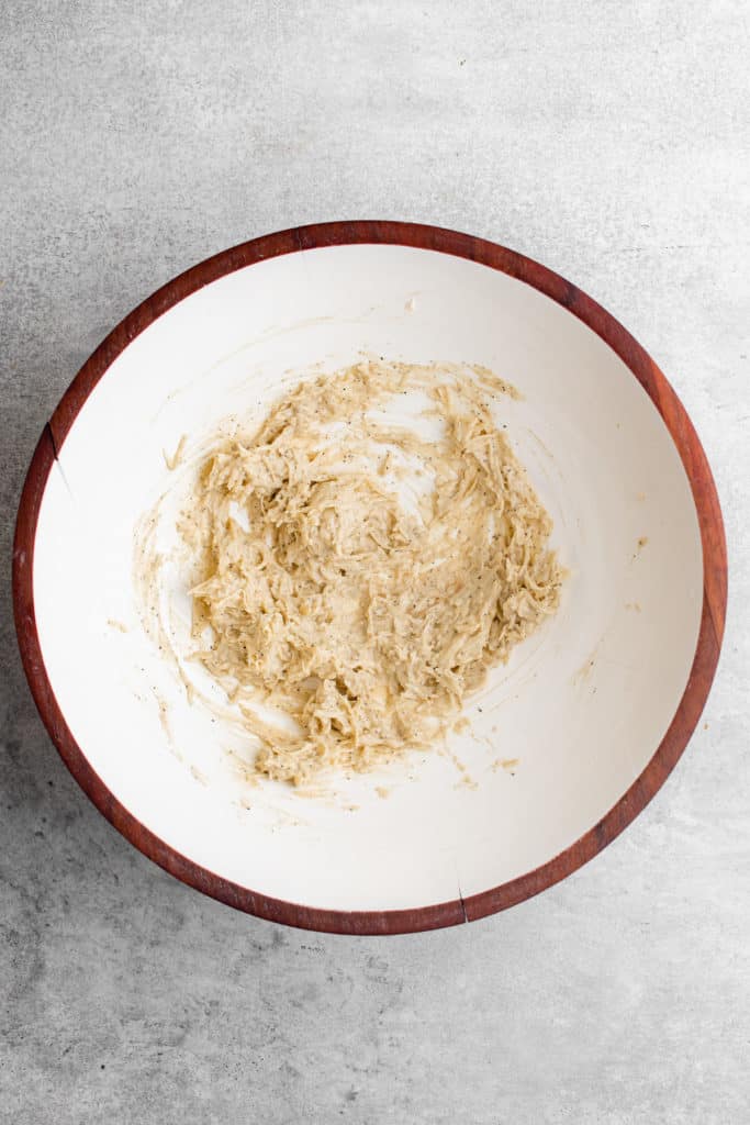 Top down view of caesar dressing in a mixing bowl.