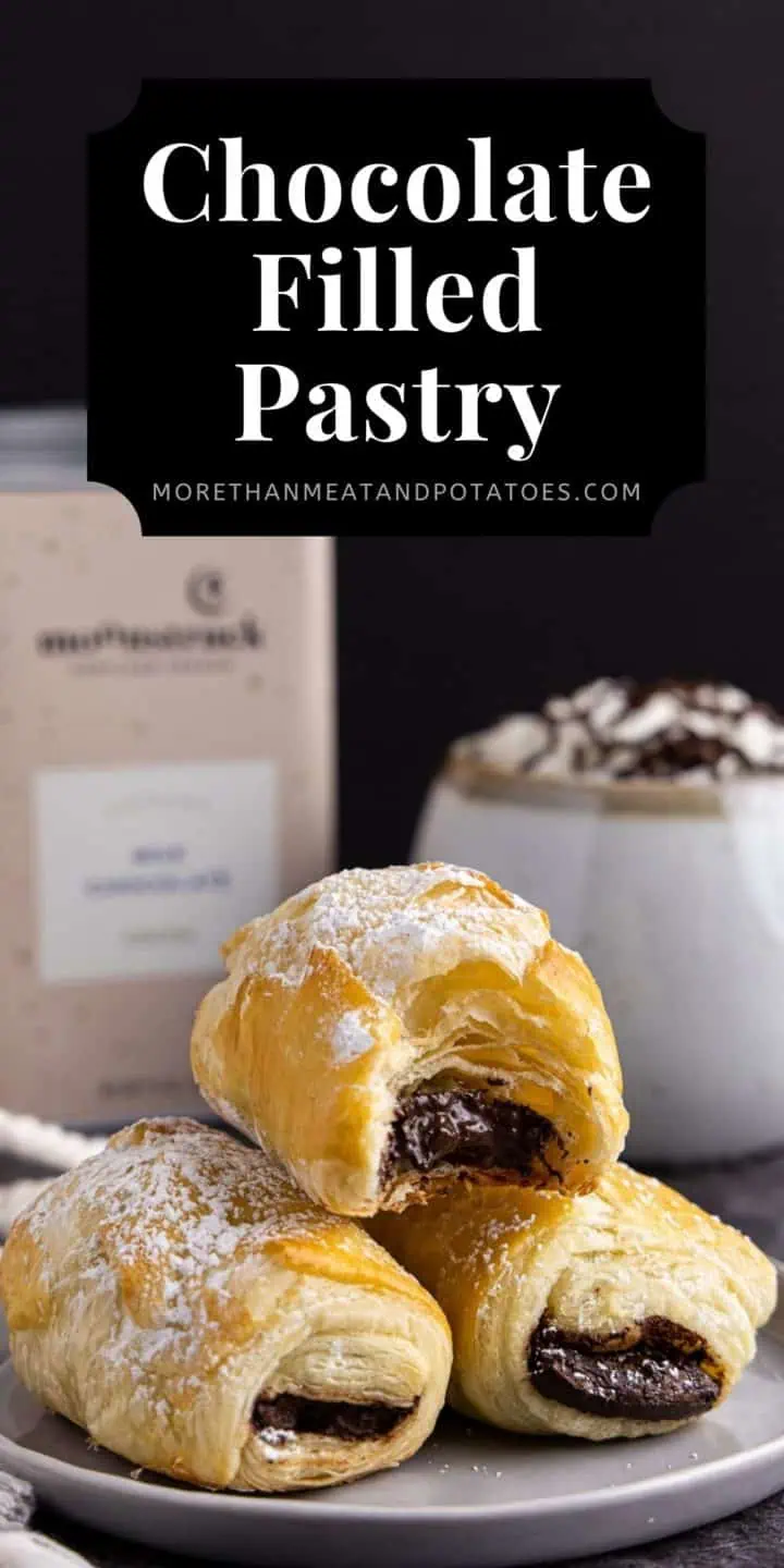 Three chocolate filled pastries in a stack.