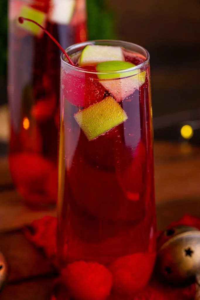 Close up view of a tall glass filled with christmas mocktail.