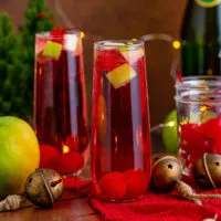 Display of christmas mocktail with champagne and fruit.