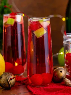 Display of Christmas mocktail with champagne and fruit.