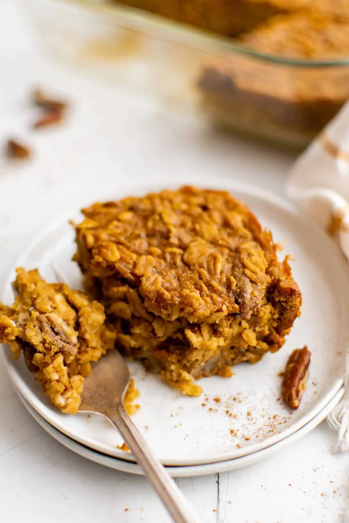Easy Pumpkin Baked Oatmeal Slice of pumpkin baked oatmeal on a plate.
