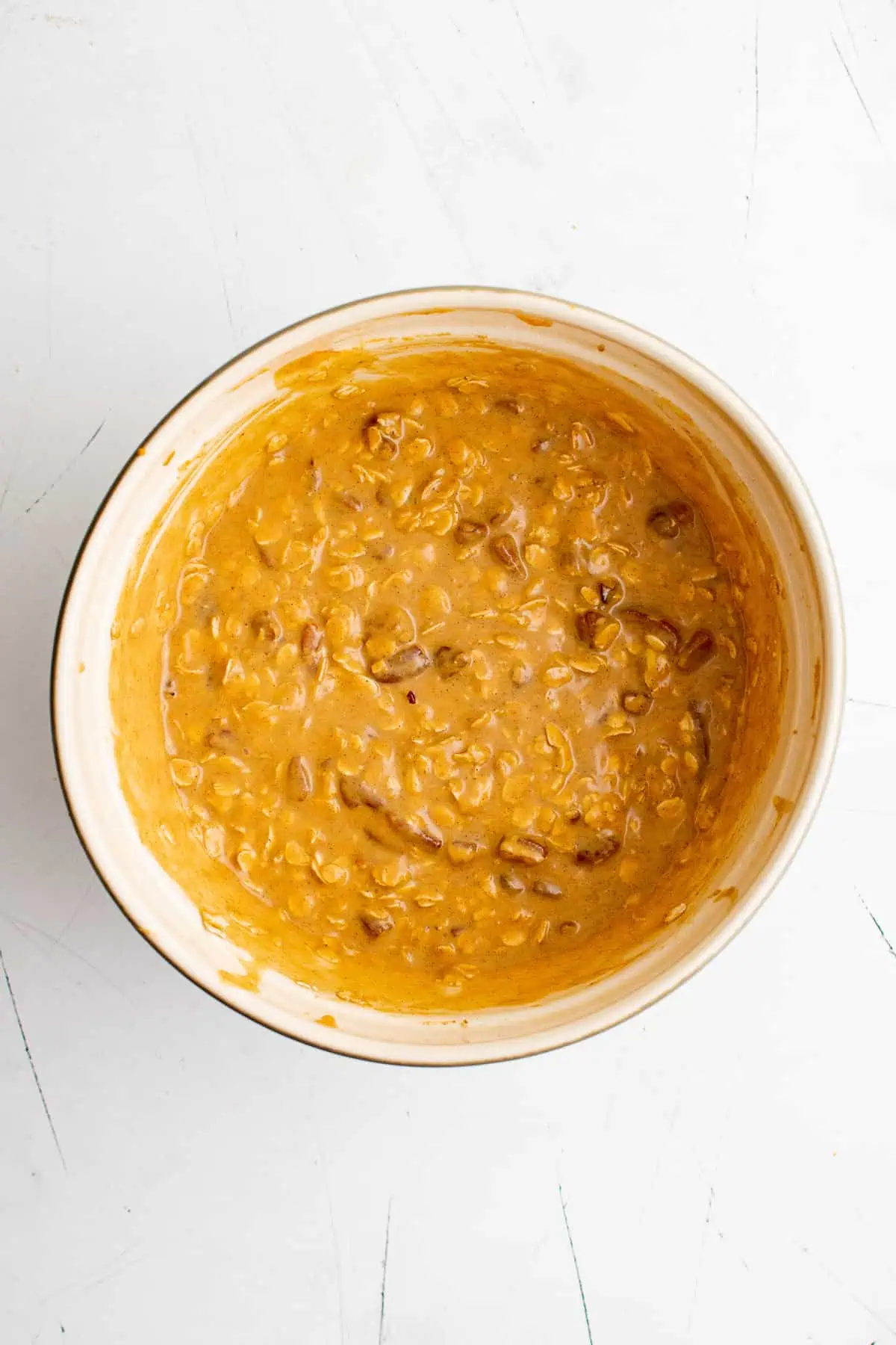 Easy Pumpkin Baked Oatmeal Pumpkin oatmeal batter in a mixing bowl.