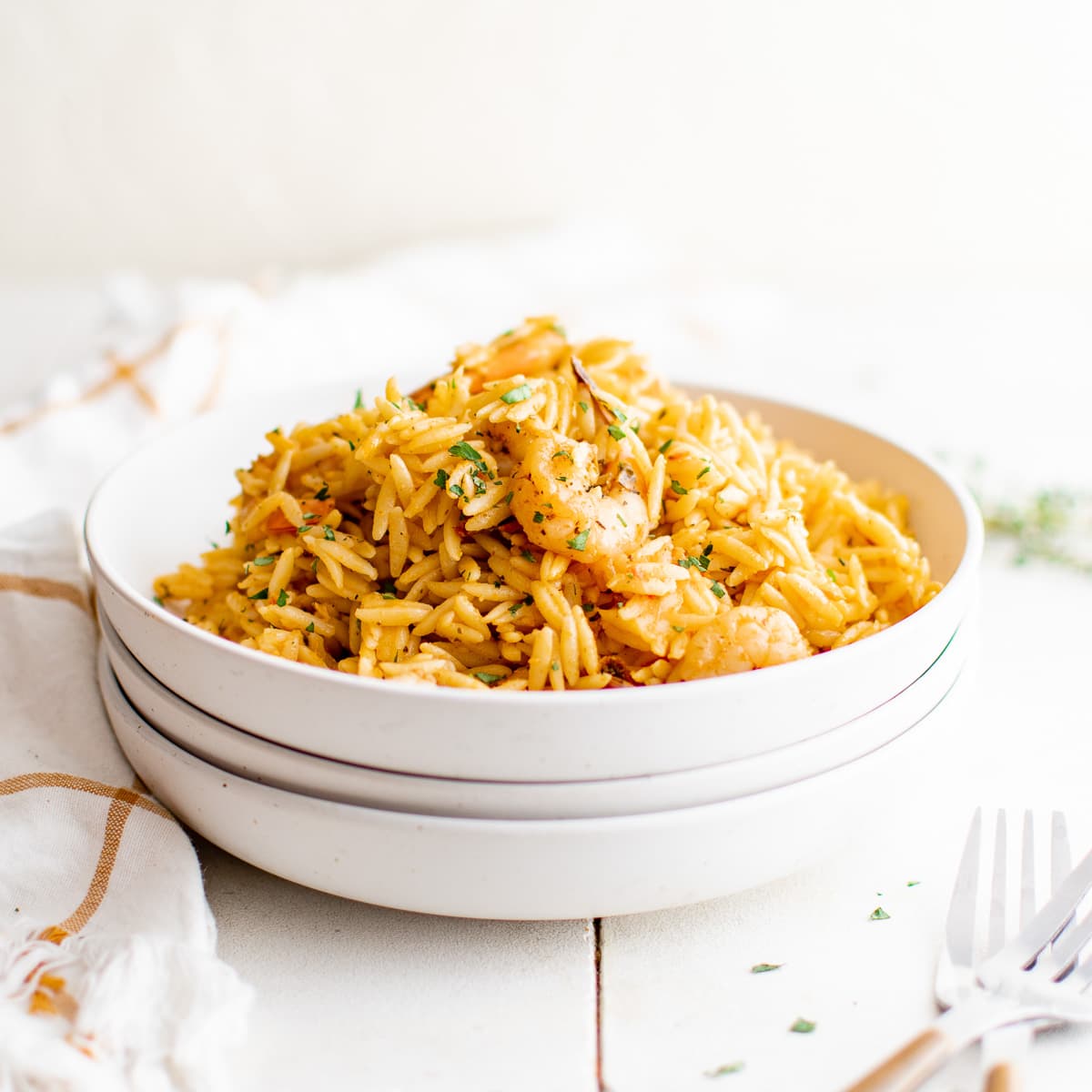 White bowl piled high with shrimp orzo.