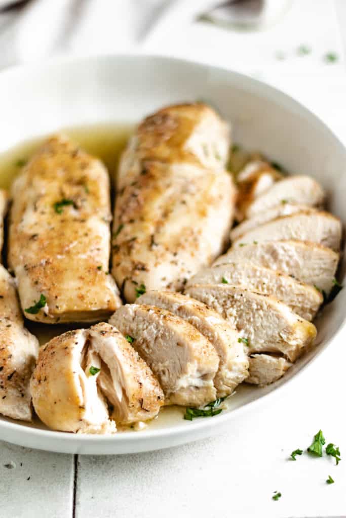 Slow cooker chicken breasts sliced in a bowl.