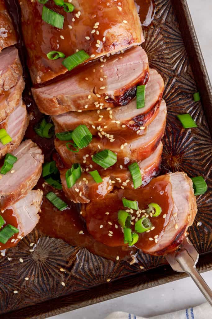 Close up view of pork tenderloin on a fork.