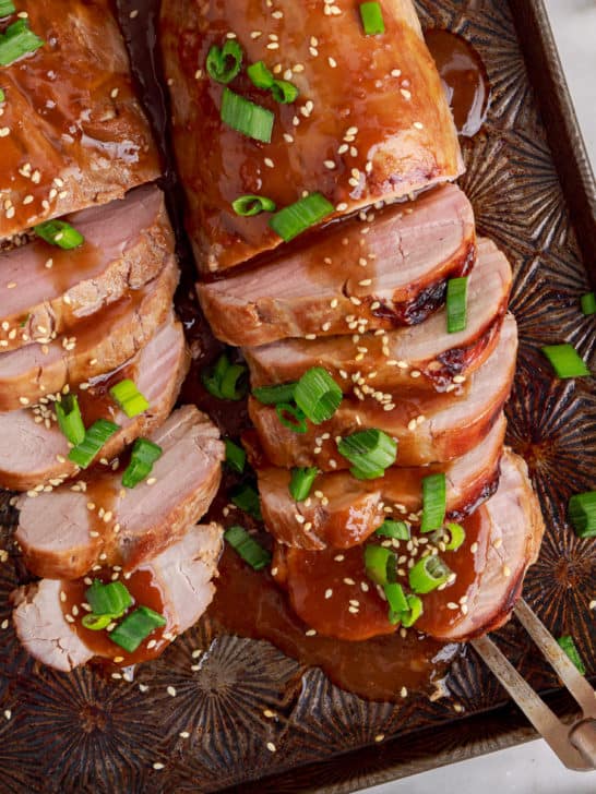 Top down view of a serving fork with teriyaki pork tenderloin.