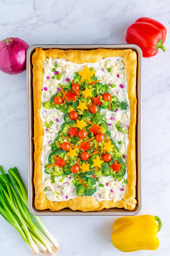 Top down view of a christmas tree shaped veggie pizza.