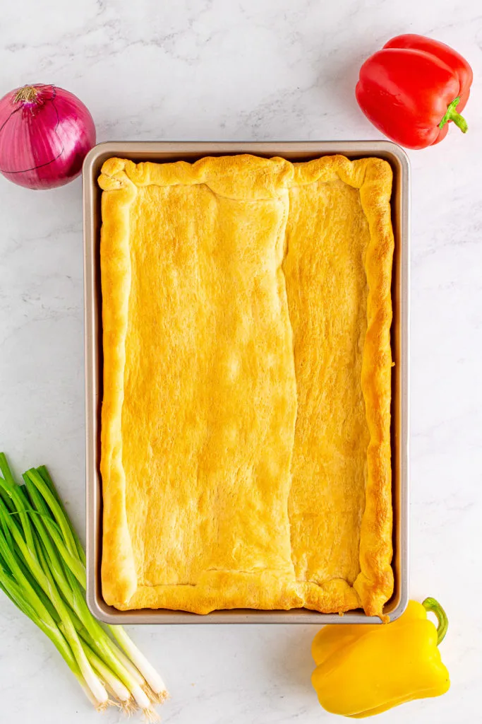 Top down view of a baked crescent roll crust.