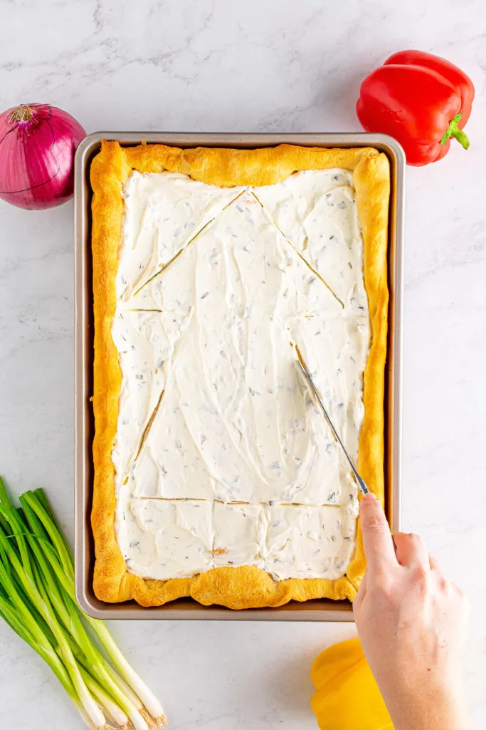 Cream cheese spread over a crescent roll crust.