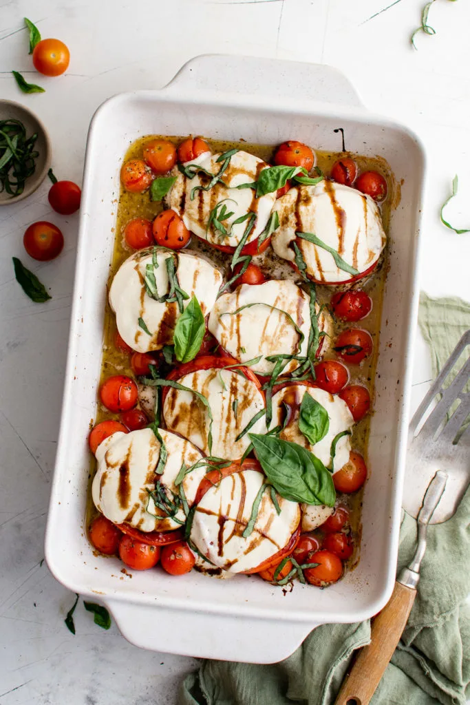 Top down view of chicken caprese in a baking dish.