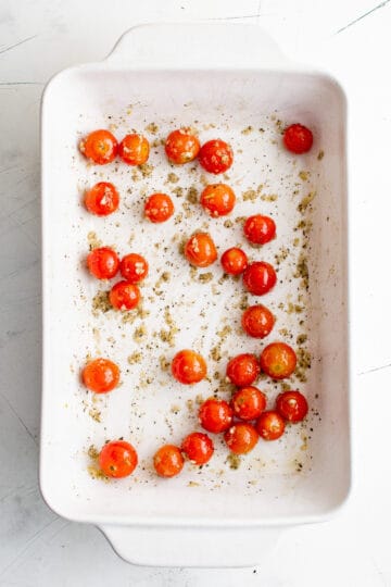 Cherry tomatoes placed in a baking sheet.