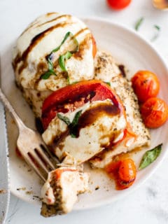 Chicken caprese on a small plate.
