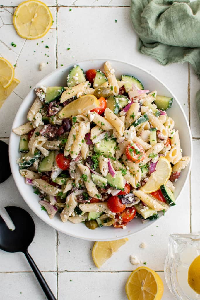 Top down view of Greek pasta salad in a large serving platter.