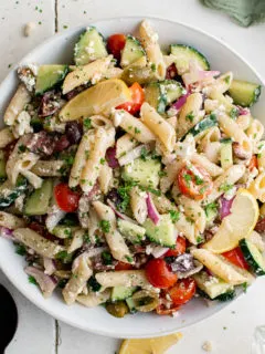 Top down view of a large bowl of Greek pasta salad.