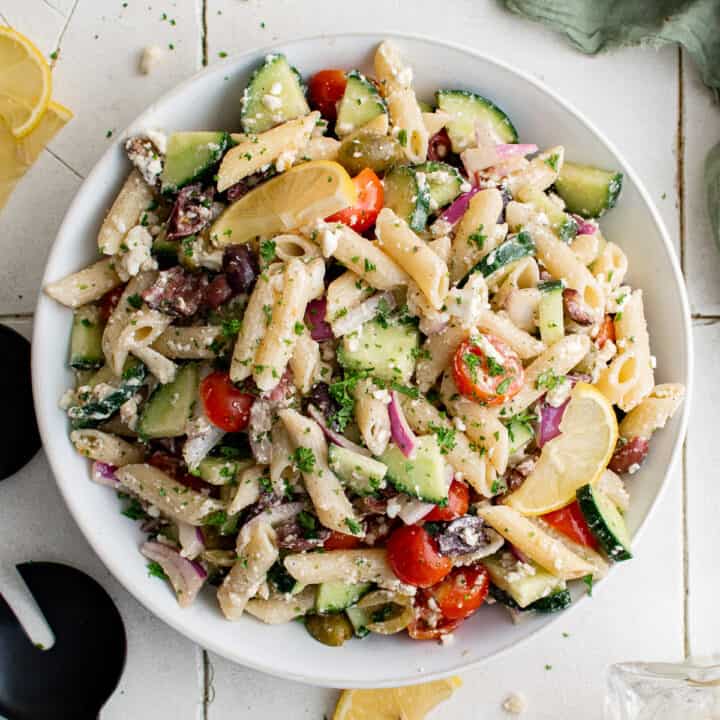 Top down view of a large bowl of Greek pasta salad.