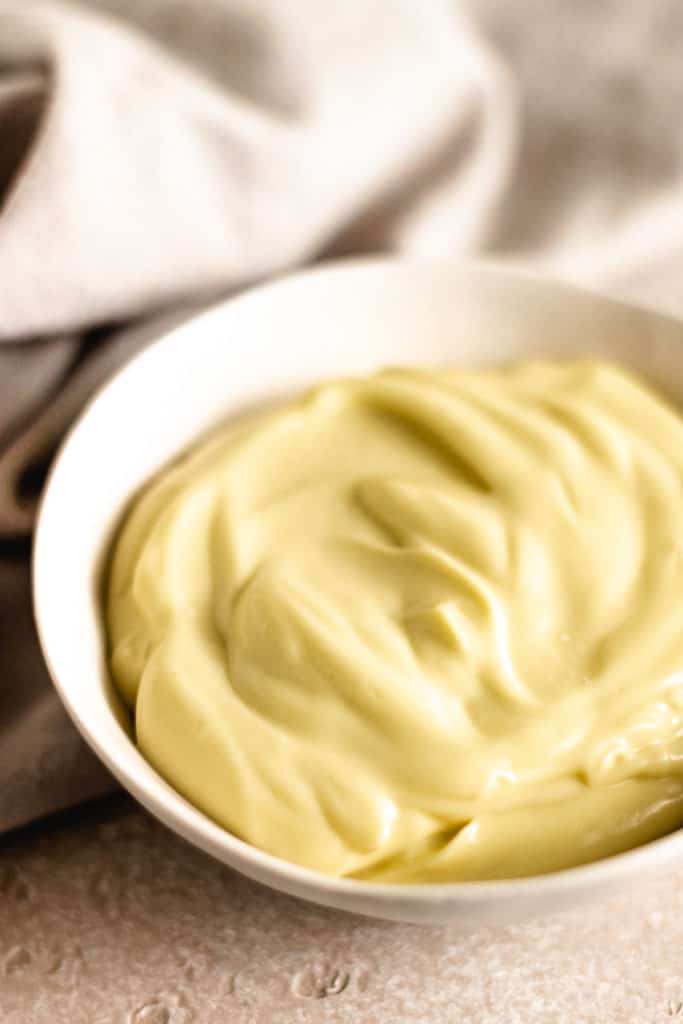 Close up view of homemade mayonnaise in a dish.