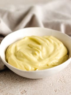 Small white dish filled with homemade mayo.