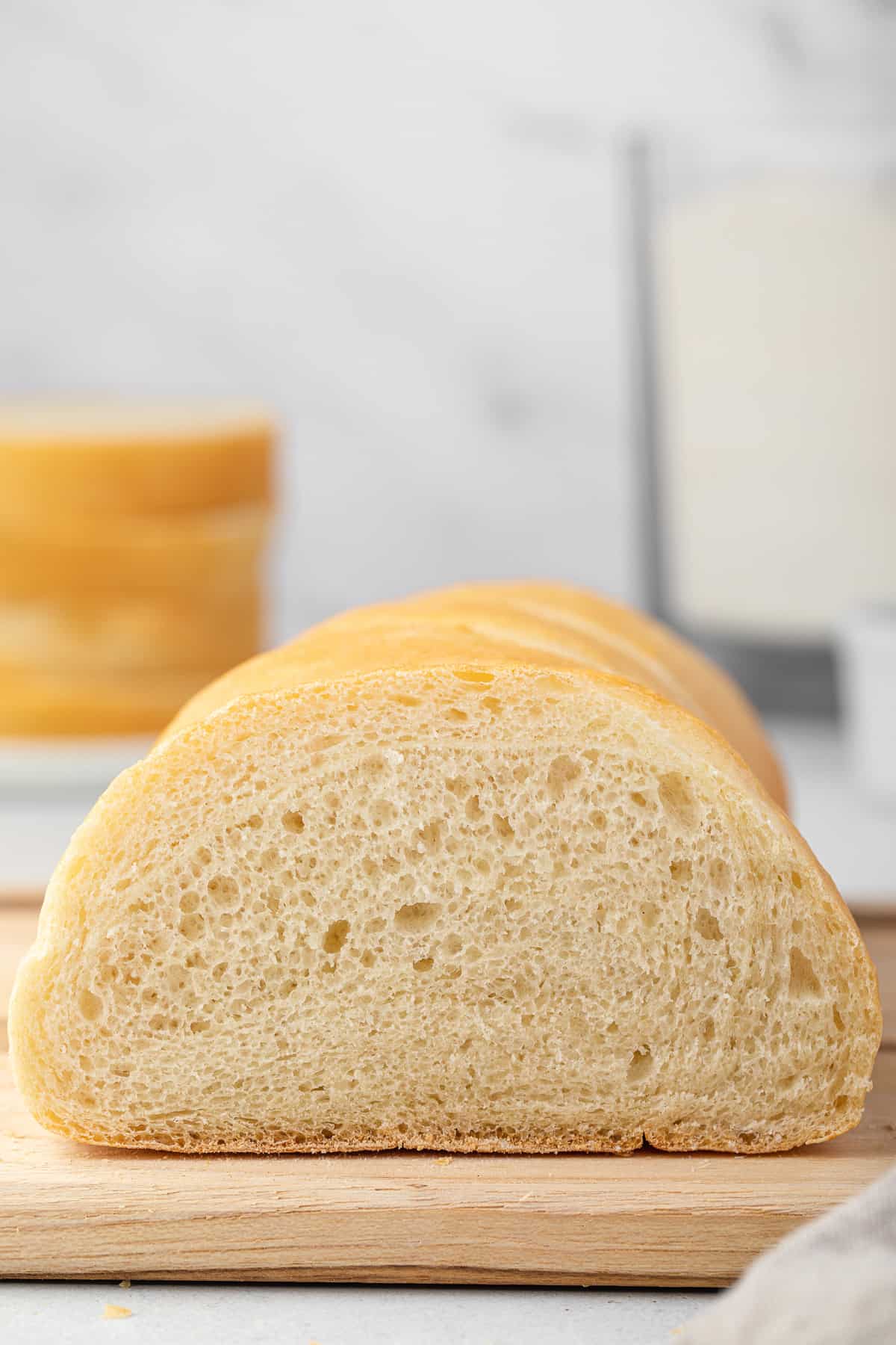 Side view of Italian bread sliced on a cutting board.