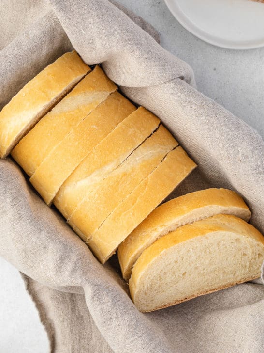 Loaf of Italian bread sliced in a basket.