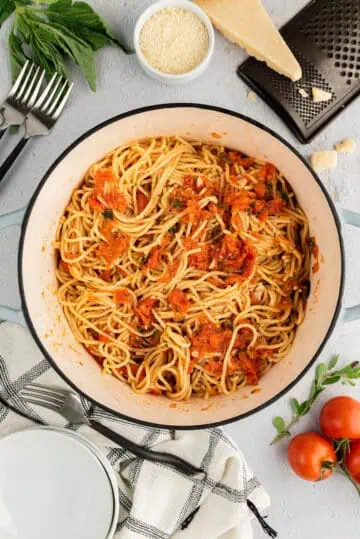 Top down view of tomato basil pasta in a large pan.