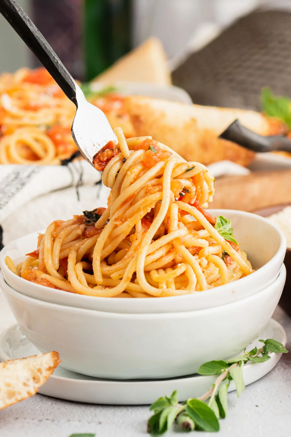 Fork lifting up pasta from a bowl.