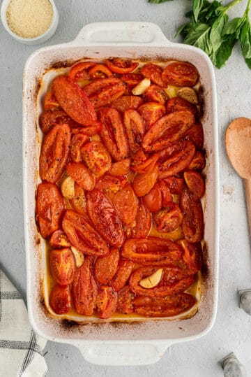 Roasted tomatoes and garlic in a baking dish.