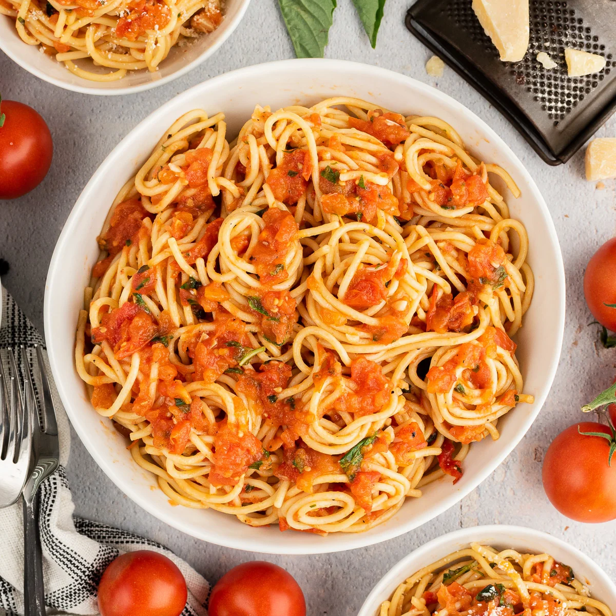 Top down view of a bowl of tomato basil pasta.