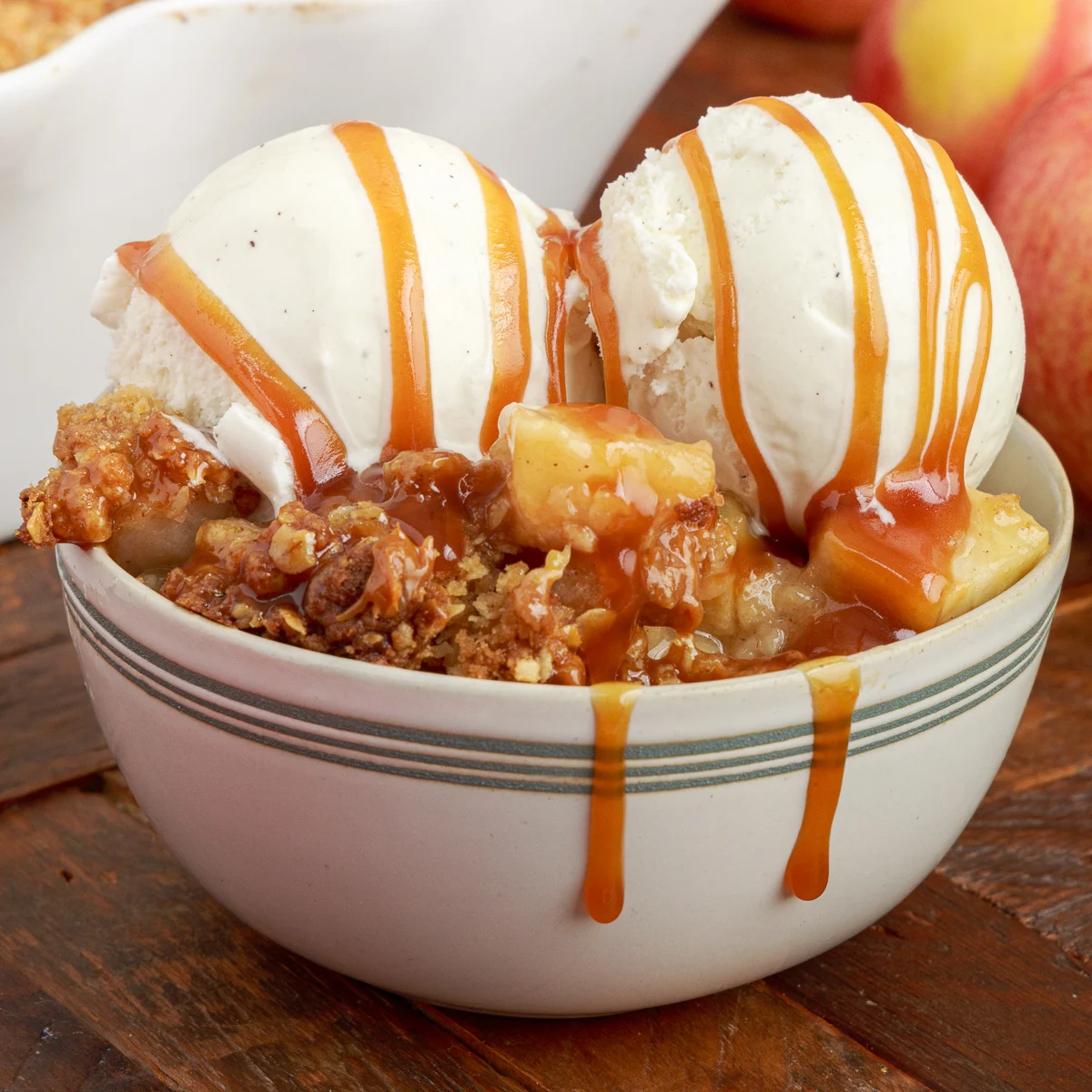 Two scoops of ice cream on apple crisp.