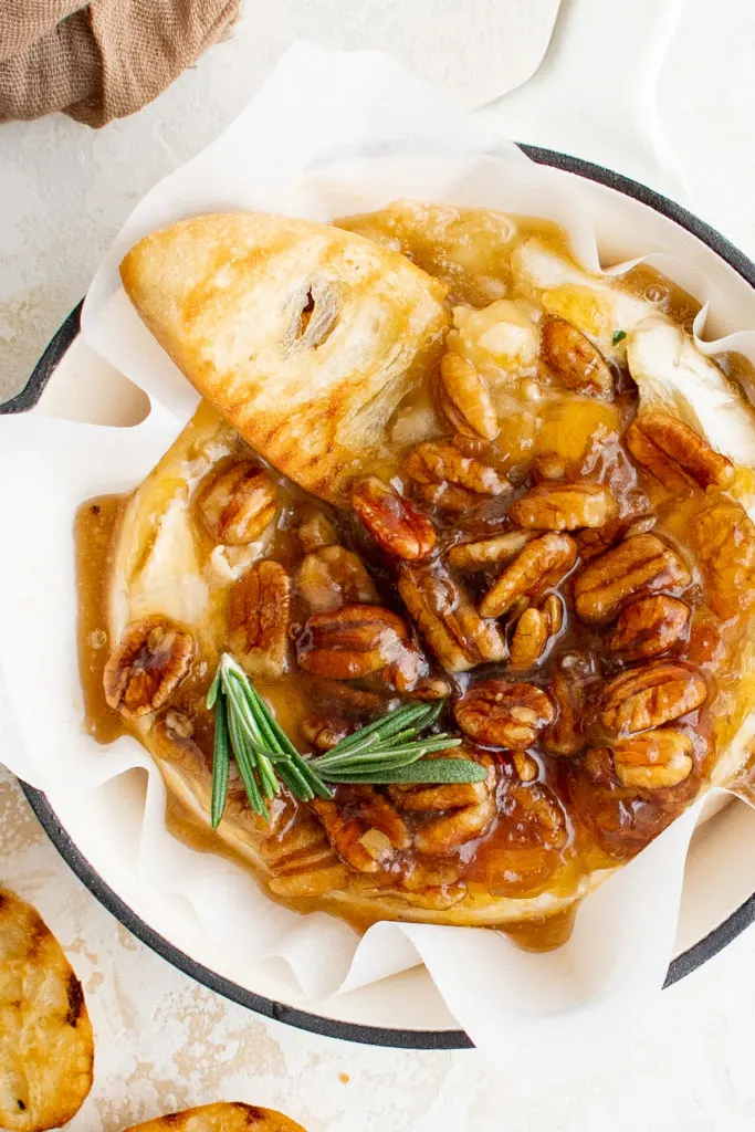 Top down view of apricot and pecan baked brie in a pan.