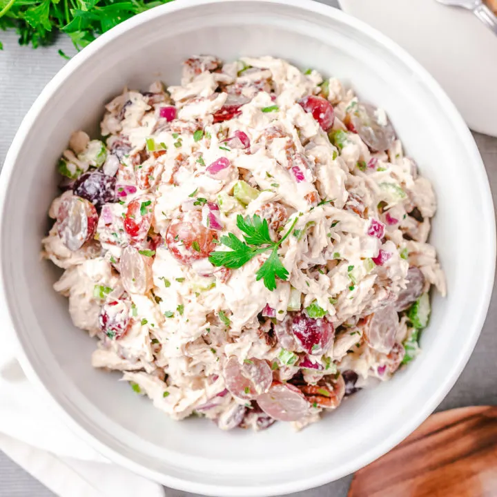 Close up view of chicken salad in a white dish.