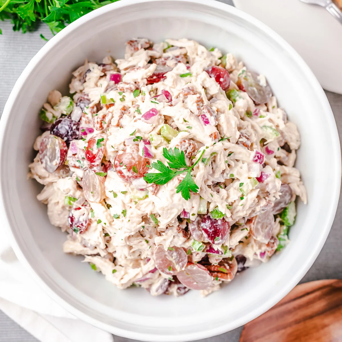 Close up view of chicken salad in a white dish.